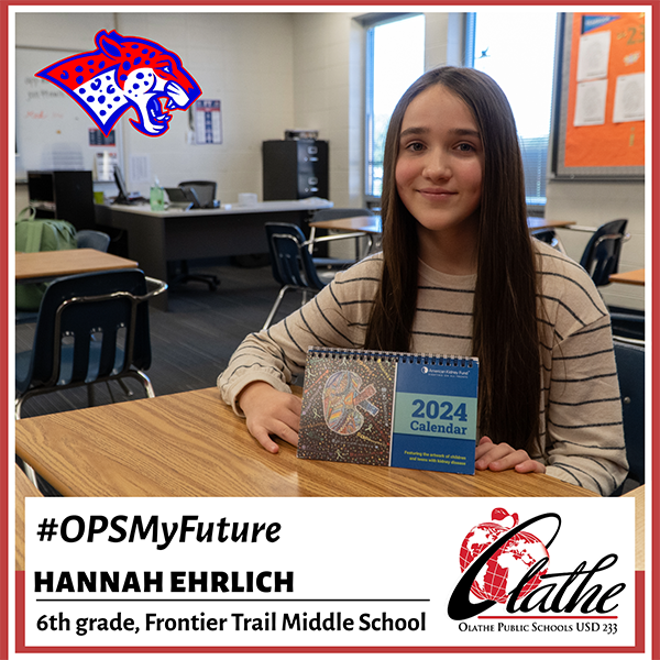 Hannah holds calendar with her art on the cover